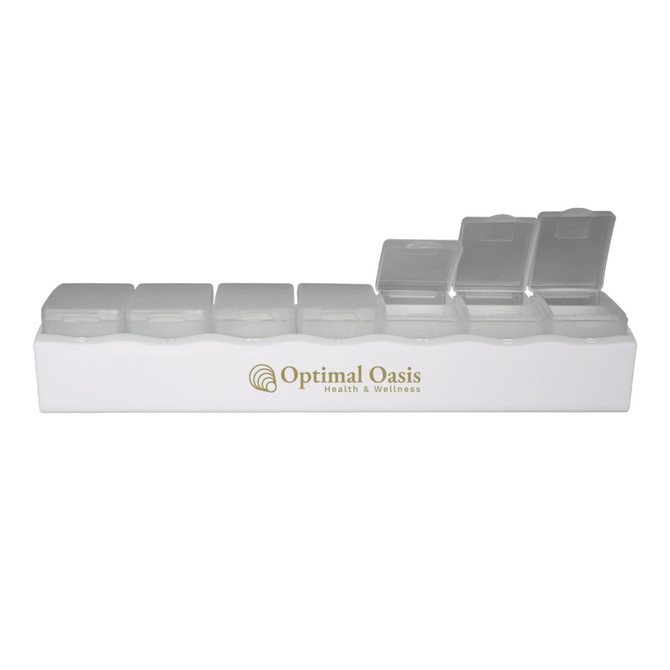 A white weekly pill box featuring multiple clear compartments and a logo.