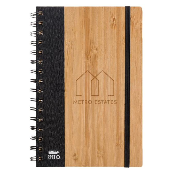 A spiral-bound A5 notebook with a bamboo cover, black fabric side, and an elastic band. It features a logo on the front.