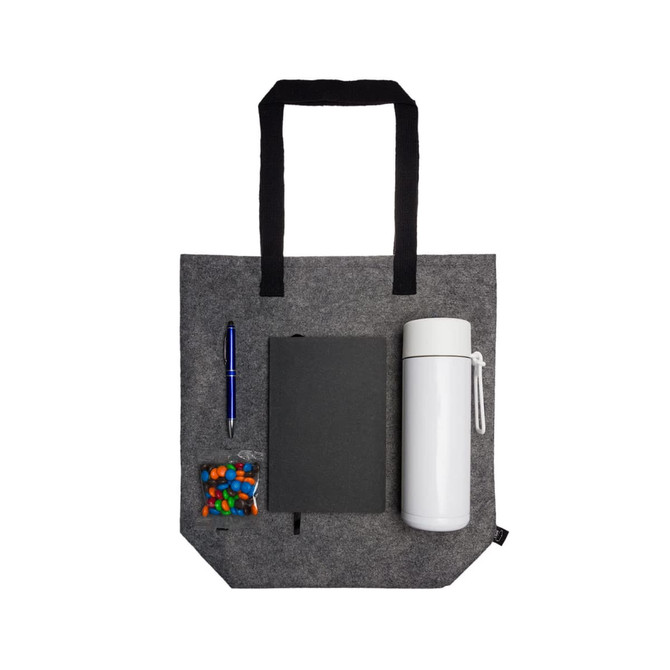 A gray tote bag with a white drink bottle, a black notebook, a pen, and a small container of colorful candies.