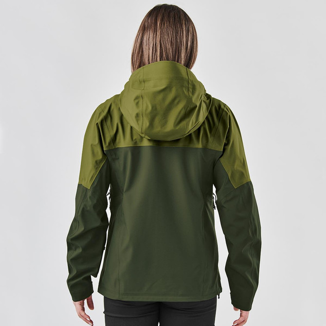 A woman wearing a dark green jacket with a hood, seen from the back. The jacket features a logo.