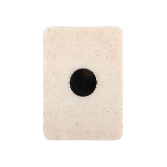 A creamy white magnetic clip with a circular black centre and a smooth, textured surface.