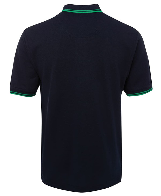 A navy polo shirt with green contrast detailing on the collar and sleeves, featuring a branding logo.