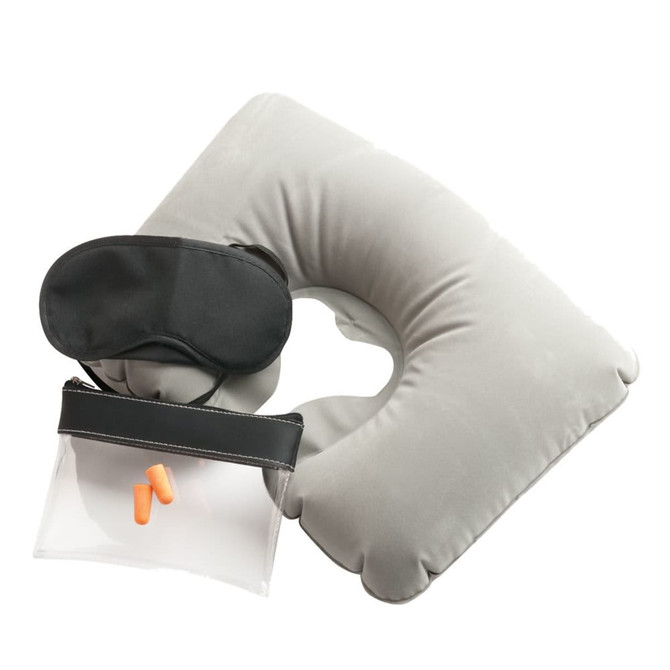 A grey travel neck pillow, black eye mask, ear plugs, and a clear toiletry bag.