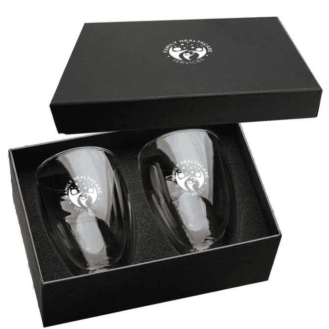 A glass coffee and tea set featuring two clear glasses in a black gift box, with a logo on each glass.