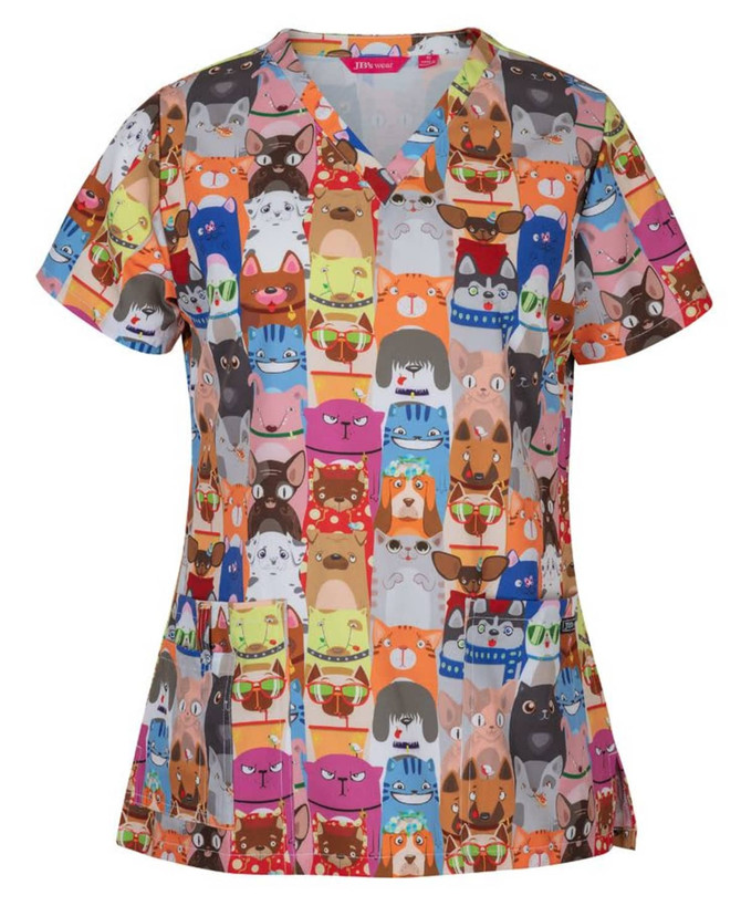 A colourful scrub top featuring a vibrant array of animal faces in various styles and accessories, with a logo.