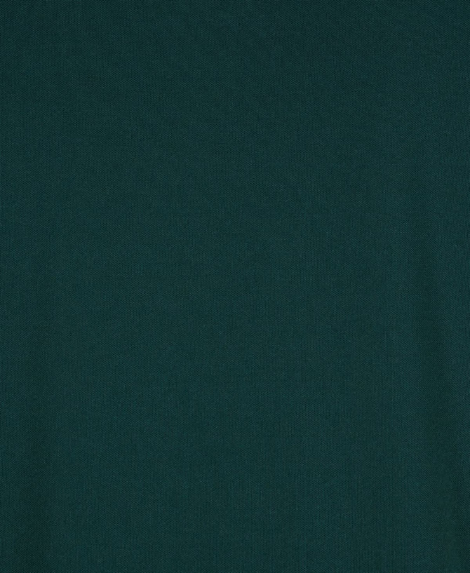 A dark green fabric texture of a polo shirt, featuring a pocket and a logo.