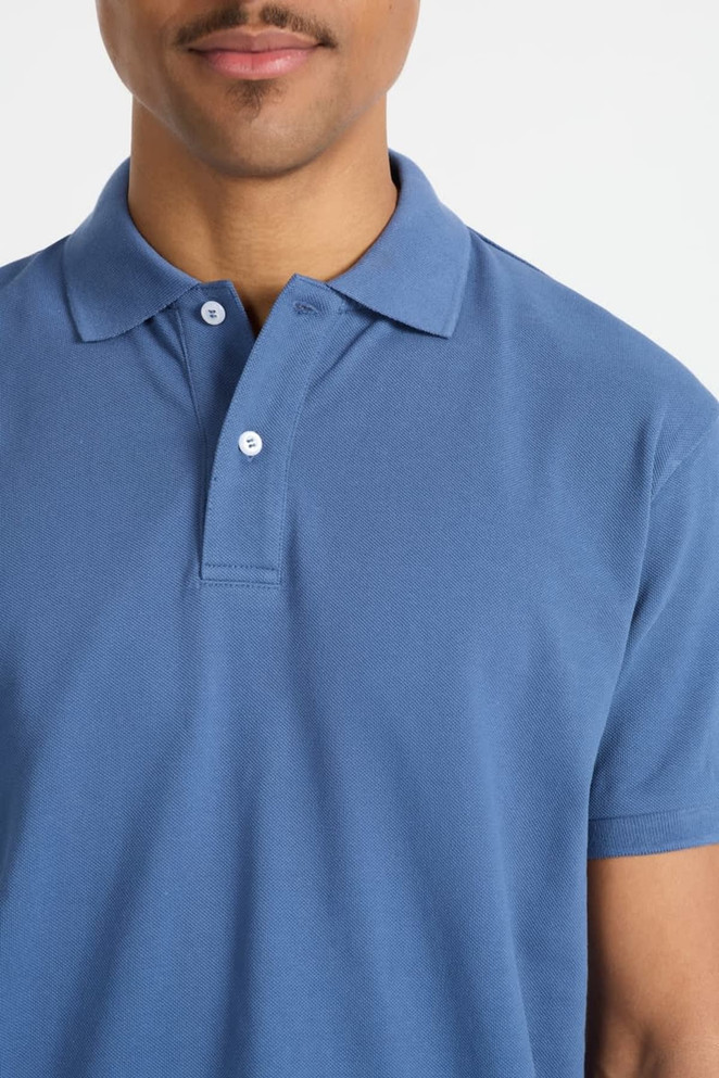 A blue men's polo shirt featuring a classic collar and button placket, showcasing a subtle branding element.
