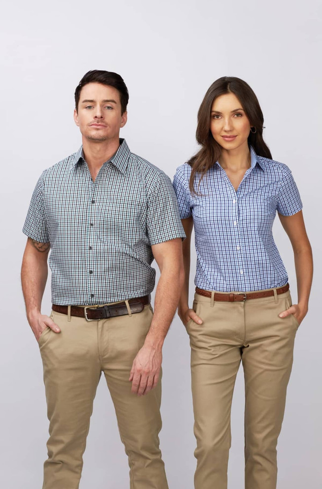 A short sleeve button-up shirt in blue and white check pattern worn by a man and woman, paired with beige trousers.