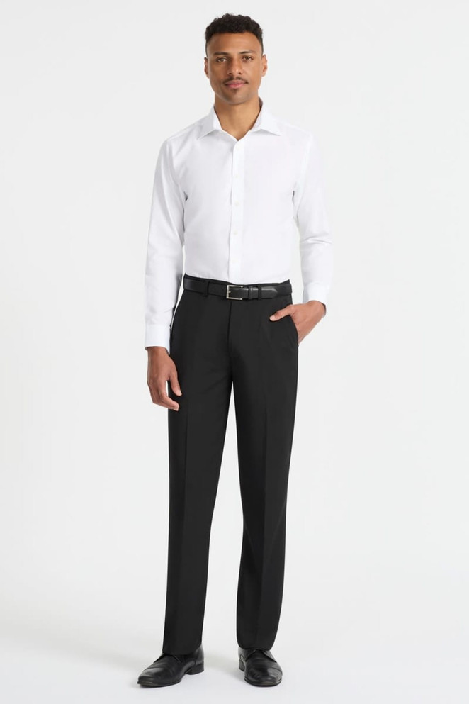 A man wearing a white long sleeve button-up shirt paired with black trousers and shoes, showcasing a sleek look.