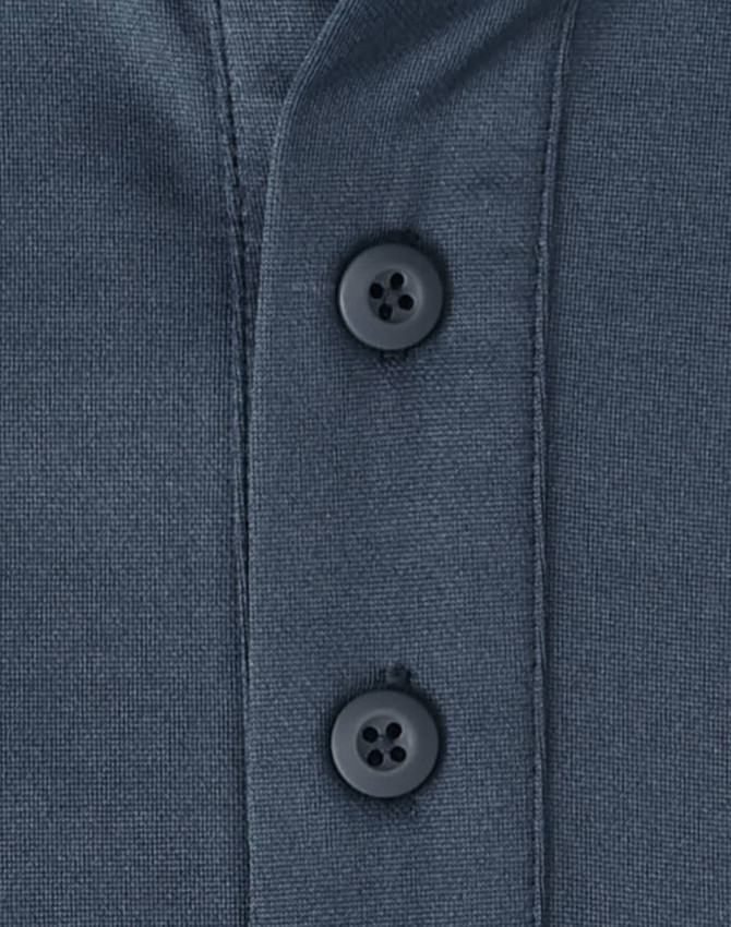 A close-up of a men's sustainable poly/cotton polo shirt in a dark colour, featuring two black buttons at the collar.