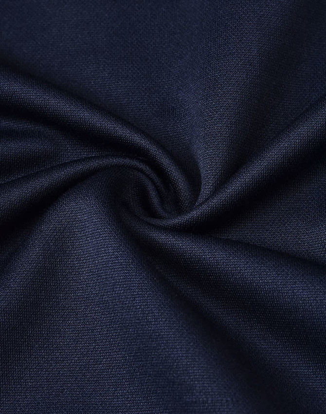 A close-up of navy blue sustainable poly/cotton fabric, showcasing its smooth texture and weave pattern.
