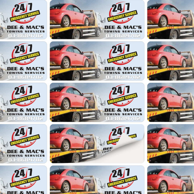 A sheet of stickers featuring a red car and a towing service logo, in a combination of yellow, black, and grey.
