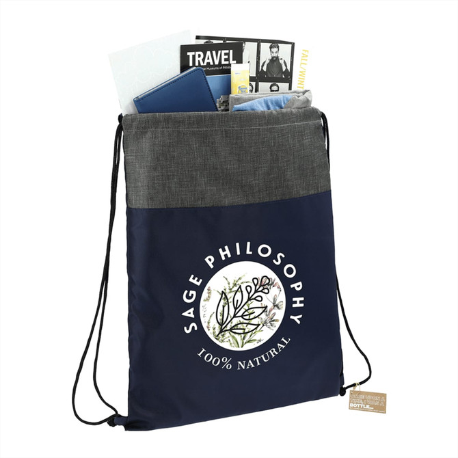 A navy and grey drawstring bag filled with various items including travel books and a notebook. It features a logo.