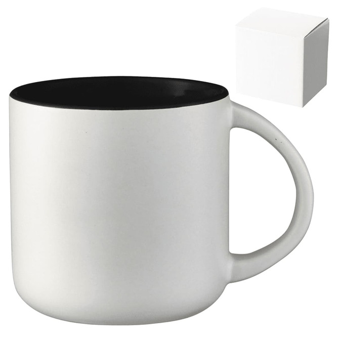 A ceramic mug with a white exterior and black interior, presented alongside a plain gift box.