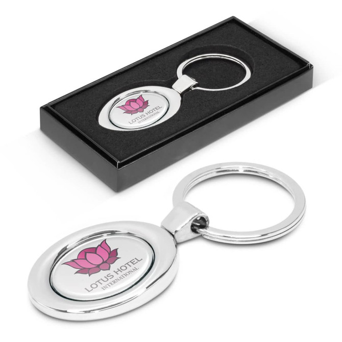 An oval metal key ring featuring a lotus flower design and the text "LOTUS HOTEL" presented in a black gift box.