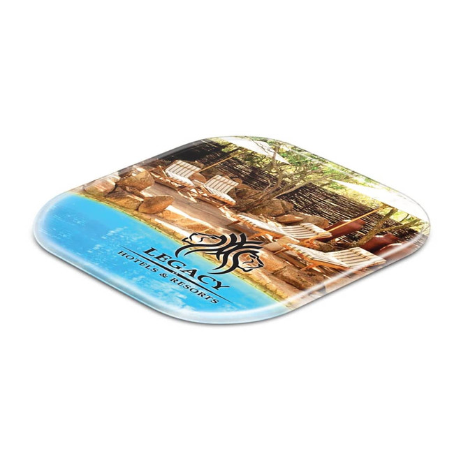 A square coaster featuring a scenic image of a resort with lounge chairs, in vibrant blue and natural tones.