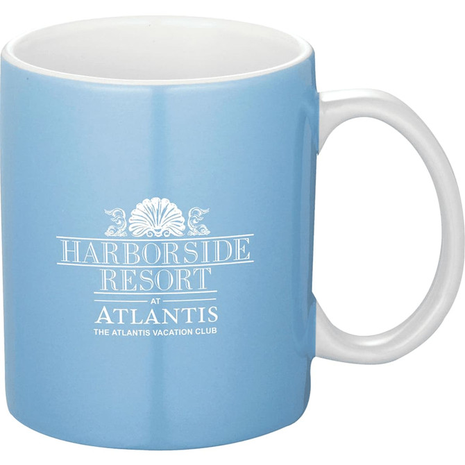 A blue ceramic mug with a white handle, featuring a logo on the side. Capacity of 325ml.