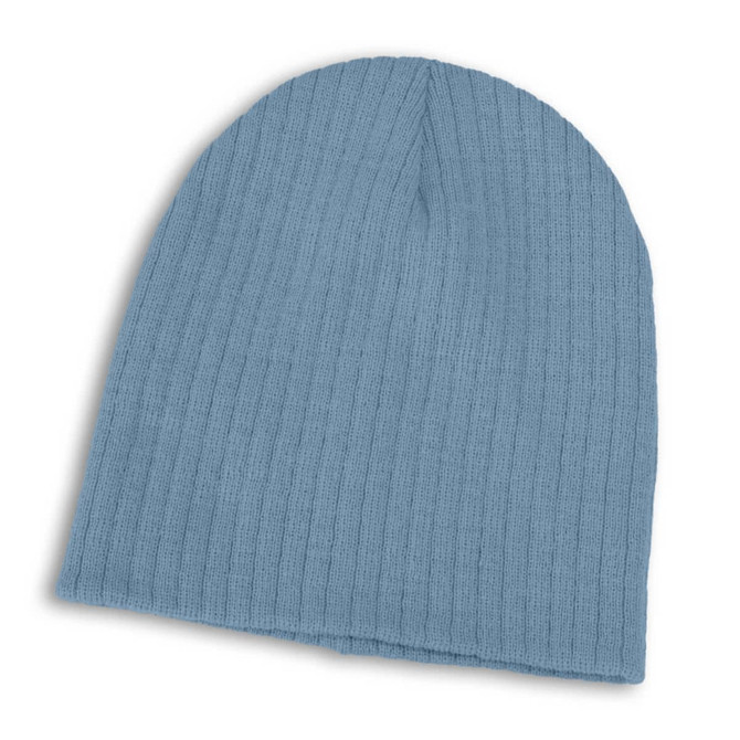 A Nebraska Cable Knit Beanie in a soft blue hue, featuring a ribbed texture for warmth and comfort.