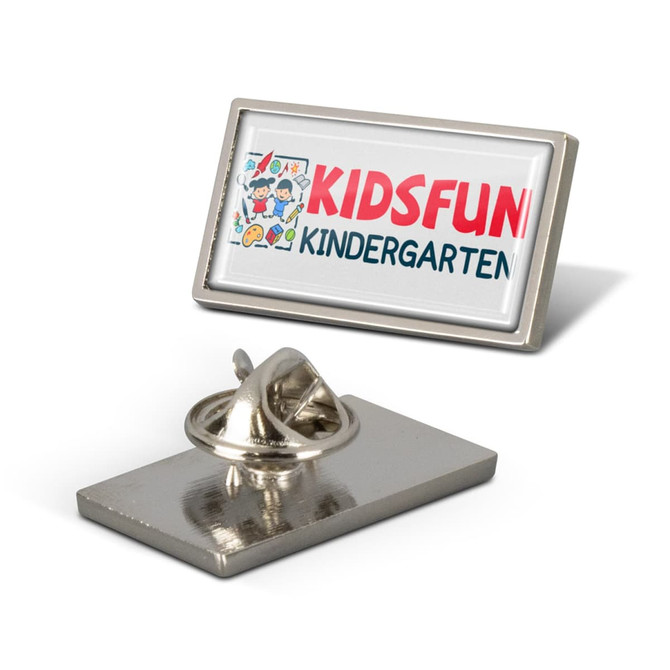 A rectangular lapel pin featuring a colourful design and a silver backing. It includes a logo and a clasp.