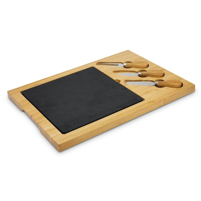 A slate cheese board with a bamboo base and three wooden-handled cheese knives. Features a smooth black surface.