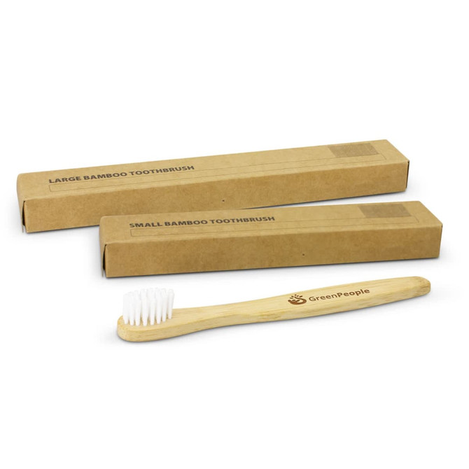 A bamboo toothbrush with a wooden handle and white bristles, displayed alongside two kraft packaging boxes.