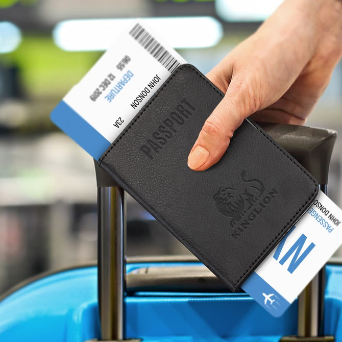 A black passport wallet holding travel documents, resting on the handle of a suitcase. It features a logo.