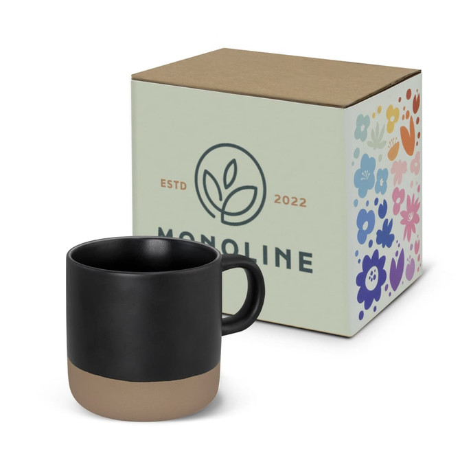 A coffee mug in black with a beige base, accompanied by a decorative box featuring a floral design and logo.