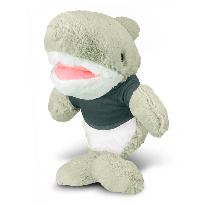 A green shark plush toy wearing a dark shirt, featuring a soft body and smiling expression.