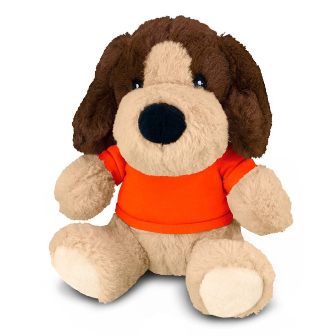 A plush dog toy with brown and tan fur, wearing an orange shirt, sitting down. It has a friendly expression and soft features.