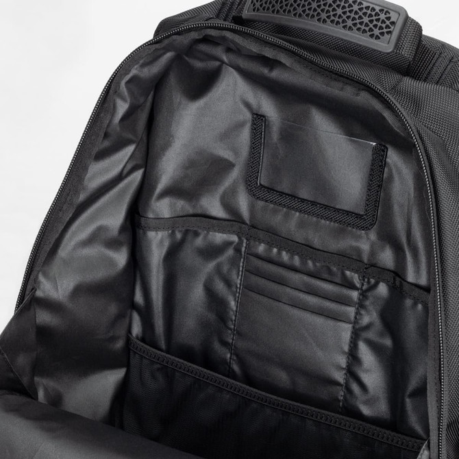 A black backpack interior featuring multiple pockets and compartments for organisation.