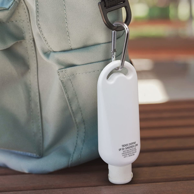 A white carabiner sunscreen bottle in a 50ml size, attached to a bag. The product features a small, sleek design.