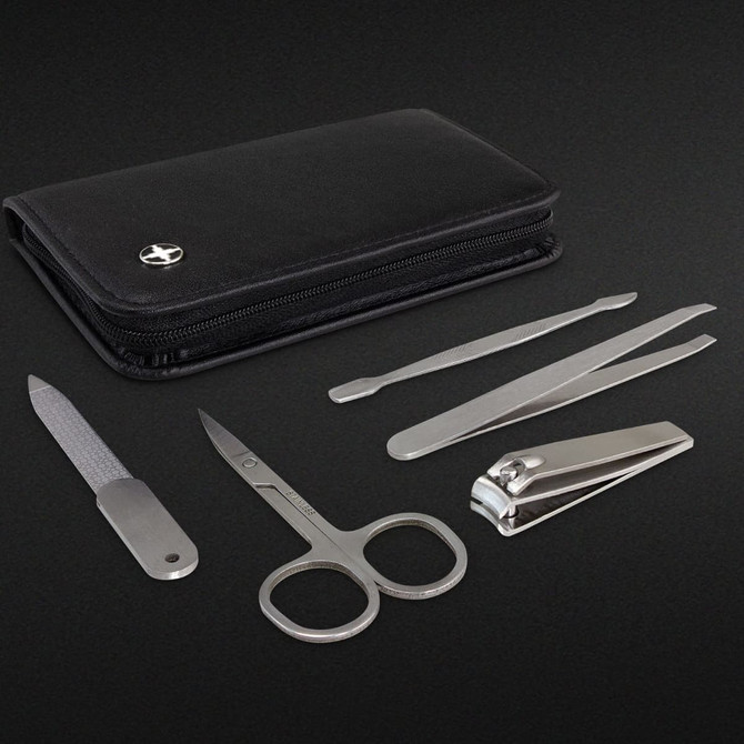 A black zippered wallet contains a nail clipper, scissors, file, tweezers, and a cuticle pusher.