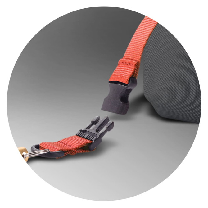 A close-up of a grey backpack strap with an orange attachment clip and buckle. The backpack features a logo.