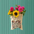 A cream canvas tote bag with a floral design, filled with vibrant sunflowers and pink dahlias.