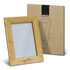 A wooden photo frame in a light brown bamboo finish, with a protective box featuring minimalistic design.