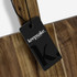 A wooden chopping board with a dark brown finish and a black branded tag attached.