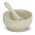 A suction bowl set featuring a soft green bowl and matching spoon, designed for kids. Includes a branding logo.