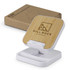A wireless charging stand with a bamboo surface and white base, accompanied by a cardboard box.