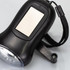 A black solar torch featuring a solar panel, a wrist strap, and an LED light. It has a smooth surface and a simple design.