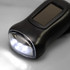 A black Dynamo Solar Torch featuring a front light and a solar panel on top. It has a sleek, compact design.
