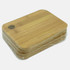 A bamboo cutting board in a stack, featuring a rounded edge and a hole for hanging. Wrapped in plastic.