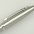 A metal pen in silver with a shiny finish and a clip, featuring a logo.