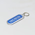 An oval acrylic keychain with a transparent border and a blue interior featuring a logo and phone number.