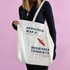 A calico tote bag with a gusset, featuring a logo and text in navy and red on a cream background.