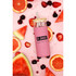 A drink bottle with a pink exterior, wooden lid, and metal straw, surrounded by fresh fruit slices and berries.