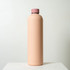 A drink bottle in a soft pink hue with a contrasting pink lid, featuring a sleek, minimal design and logo.