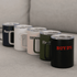 A collection of five travel mugs in navy, white, blush, olive, and black, featuring various logos.