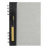 A recycled journal book in grey with a black spiral binding and a pen attached. It features branding on the cover.