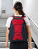 A red and black backpack featuring a mesh side pocket and bungee cord design, with adjustable straps and a logo.