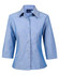 A light blue chambray shirt with 3/4 sleeves and a button-up front. The shirt features a collar and has a logo.